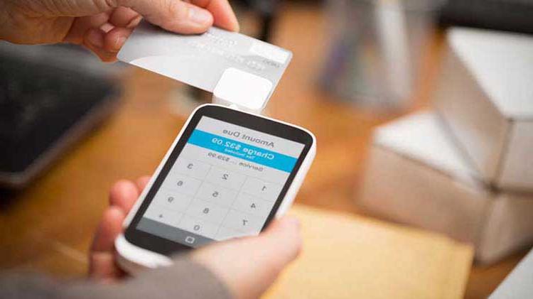 Person scanning a credit card on a smartphone.