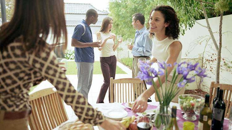 Friends enjoying a house party knowing their home is insured.