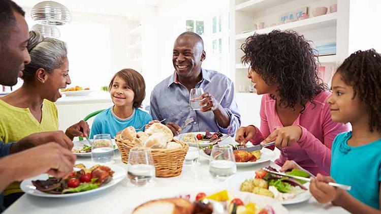 Family eating a meal together at a table.